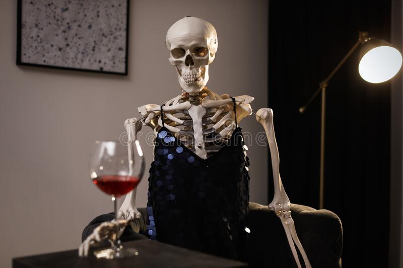 skeleton-dress-wine-sitting-table-indoors-170611509.jpg
